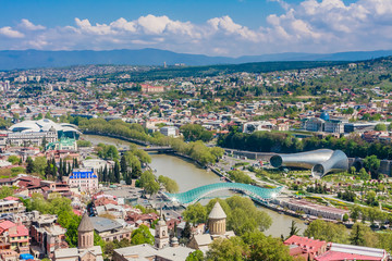 Fototapeta na wymiar Panoramic view of Tbilisi city from the Narikala Fortress, old town and modern architecture. Georgia