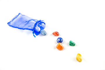 Colored stones out of a little sack. Each color represents one chakra