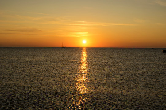 Photo of the sea sunrise in warm tones and the sun path