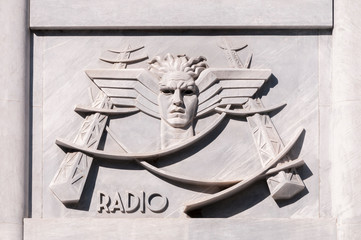 Bas-relief in fascist style depicting the telegraph service, on the facade of the central post office in Carrara, Italy.