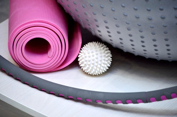 Sports equipment for a healthy sports lifestyle. Dumbbells, hand or foot weights, massage ball, elastic bands, bandages, a roll for the press, an expander hoop and others