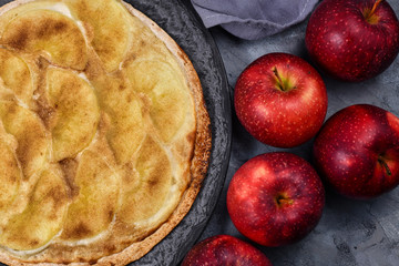 Sweet `Tarte Flambee` or `Flammkuchen` from German-French Alsace border region, a baked pie similar to a thin pizza topped with apple slices, sugar and cinnamon 