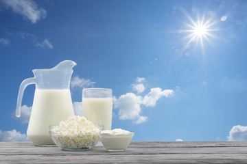 Dairy products in glass bowl against blue sky