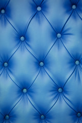 Fototapeta na wymiar Vertical background of blue leather furniture upholstery