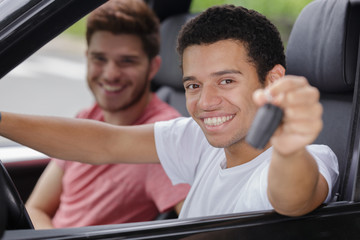 a happy man showing keys