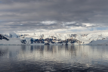 Fototapeta na wymiar Antarctic beach with glacier and mountains, view from expedition ship