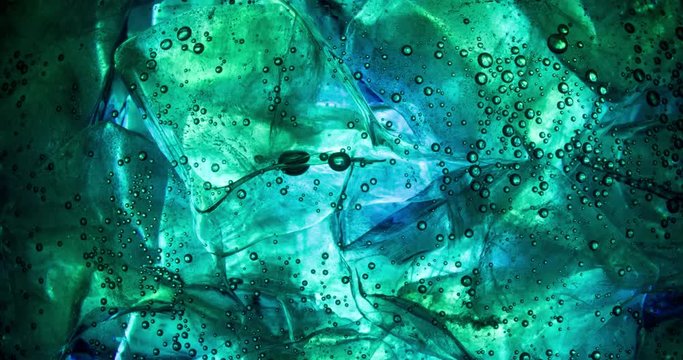 blue green Ice cubes rotating slow motion extreme closeup macro shot 4K video background abstract.