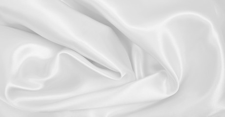 Naklejka premium Smooth elegant white silk or satin luxury cloth texture as wedding background. Luxurious background design