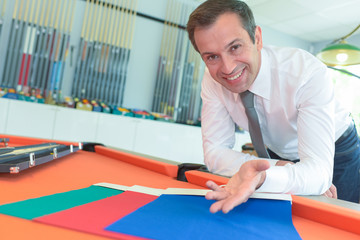 fashion designers discussing new fabric samples