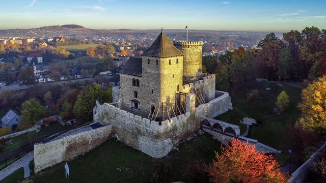  Medieval gothic castle in Bedzin, Upper Silesia, Poland. Aerial 4K revealing video in fall in sunrise light