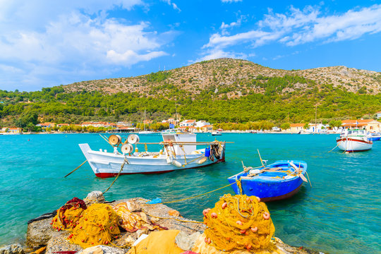 Colourful Greek fishing boats with nets on shore in Posidonio bay, Samos island, Greece