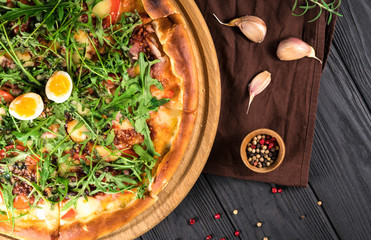 .pizza with arugula on a black background