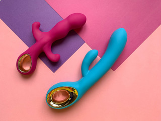 Sex toys. Pink and blue vibrators on a pink background. Useful for sex shop, adult