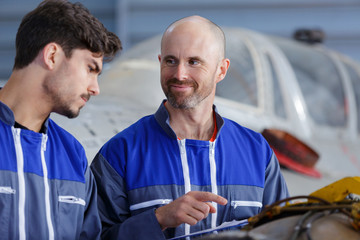 tutor and student in aircraft hangar