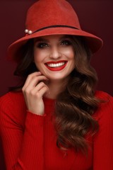 Beautiful sexy woman in a fashionable hat, with classic make-up, wave hair and red lips. Beauty face.