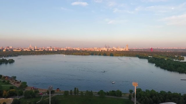 Beautiful river bay in a residential area, nature and the city in the background, aerial shot in summer, Moscow.