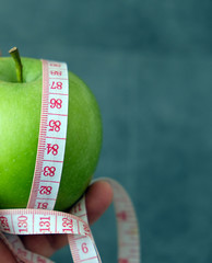 green apple and tape measure