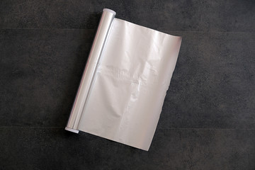 aluminum foil, rolled aluminum foil, close-up on a black background,