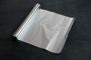 aluminum foil, rolled aluminum foil, close-up on a black background,