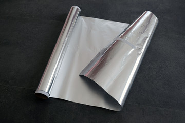 aluminum foil, rolled aluminum foil, close-up on a black background,