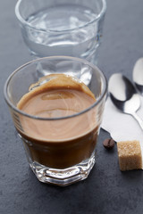Coffee with milk on dark stone background. Close up.