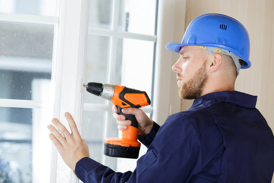 Male Builder Using A Drill