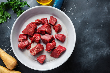 Beef chunks with ingredients served on table