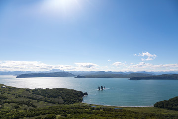 Three Brothers, Kamchatka Peninsula, Russia. A group of three pillar-shaped rocks protruding from the water (kekurs) located at the entrance to Avacha Bay.