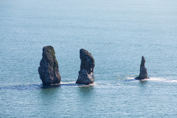 Three Brothers, Kamchatka Peninsula, Russia. A group of three pillar-shaped rocks protruding from the water (kekurs) located at the entrance to Avacha Bay.