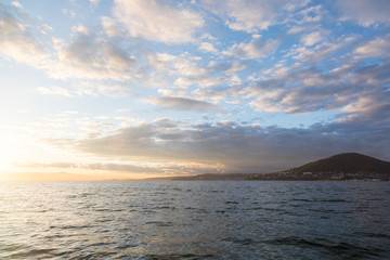 Golden sunset in the sky over the Avacha Bay, Kamchatka Peninsula, Russia.