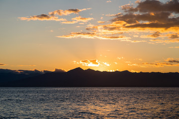 Fototapeta premium Golden sunset in the sky over the Avacha Bay, Kamchatka Peninsula, Russia.