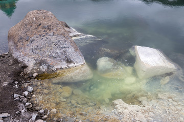 Small Valley of Geysers, Kamchatka Peninsula, Russia. This is a unique active fumarole field, the hot gases of which pass through the water of a cold stream, heating it and creating a gushing effect.