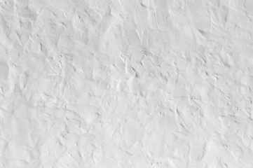 Close up on whitewashed rough wall surface. Uneven roughcast texture