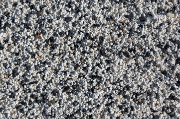 Texture of beach made of rhodoliths. Small bits of rock covered in algae, after breaking up,  washed on the beach, make this popcorn like sand