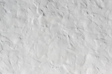 Close up on whitewashed rough wall surface. Uneven roughcast texture