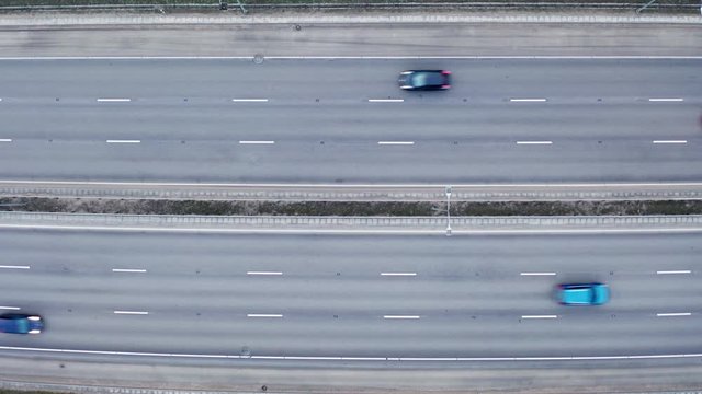 Aerial top-down view of multiline freeway traffic. Aerial view with cars on the road, camera locked