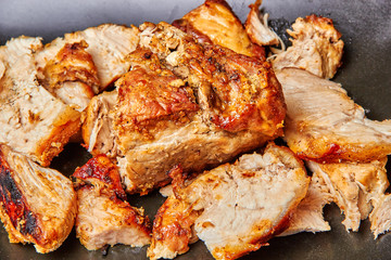 baked meat cut into pieces close up photo