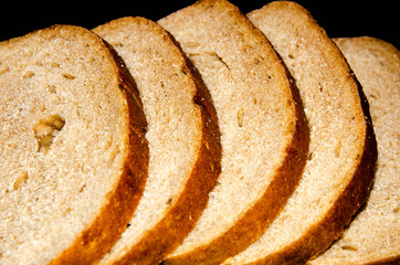 Hearth, pood bread. Black, gray, mustard. Sliced in slices, slices, slices on a choppy background.  Top view, side view. Copy Space