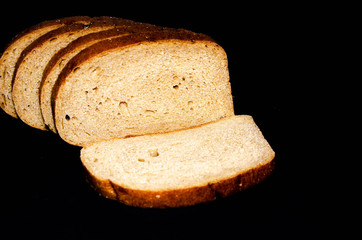 Hearth, pood bread. Black, gray, mustard. Sliced in slices, slices, slices on a choppy background.  Top view, side view. Copy Space