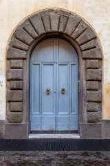 ancient grey wooden arched door, Italy Europe
