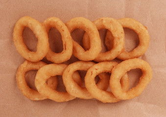 Onion rings tasty fast food meal on brown paper