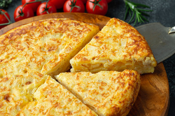 Spanish omelette with potatoes and onion, typical Spanish cuisine. Tortilla espanola - obrazy, fototapety, plakaty