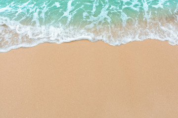 Naklejka na ściany i meble Summer beach concept - Soft wave of sea on empty sandy beach Background with copy space.