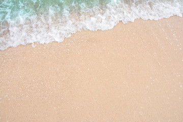 Fototapeta na wymiar Summer beach concept - Soft wave of sea on empty sandy beach Background with copy space.