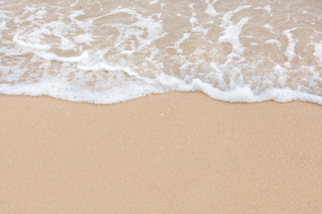 Summer beach concept - Soft wave of sea on empty sandy beach Background with copy space.