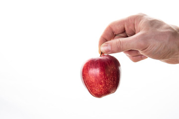 Crop person throwing ripe apple in air