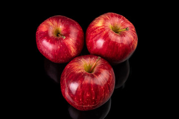 Fresh red apples placed on reflective surface