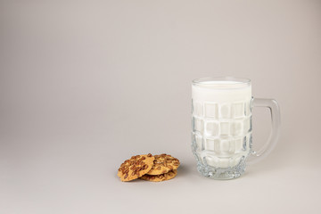 Yummy cookies near mug of fresh milk