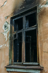 Broken window of burnt house