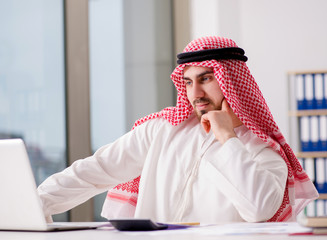 Arab businessman working on laptop computer